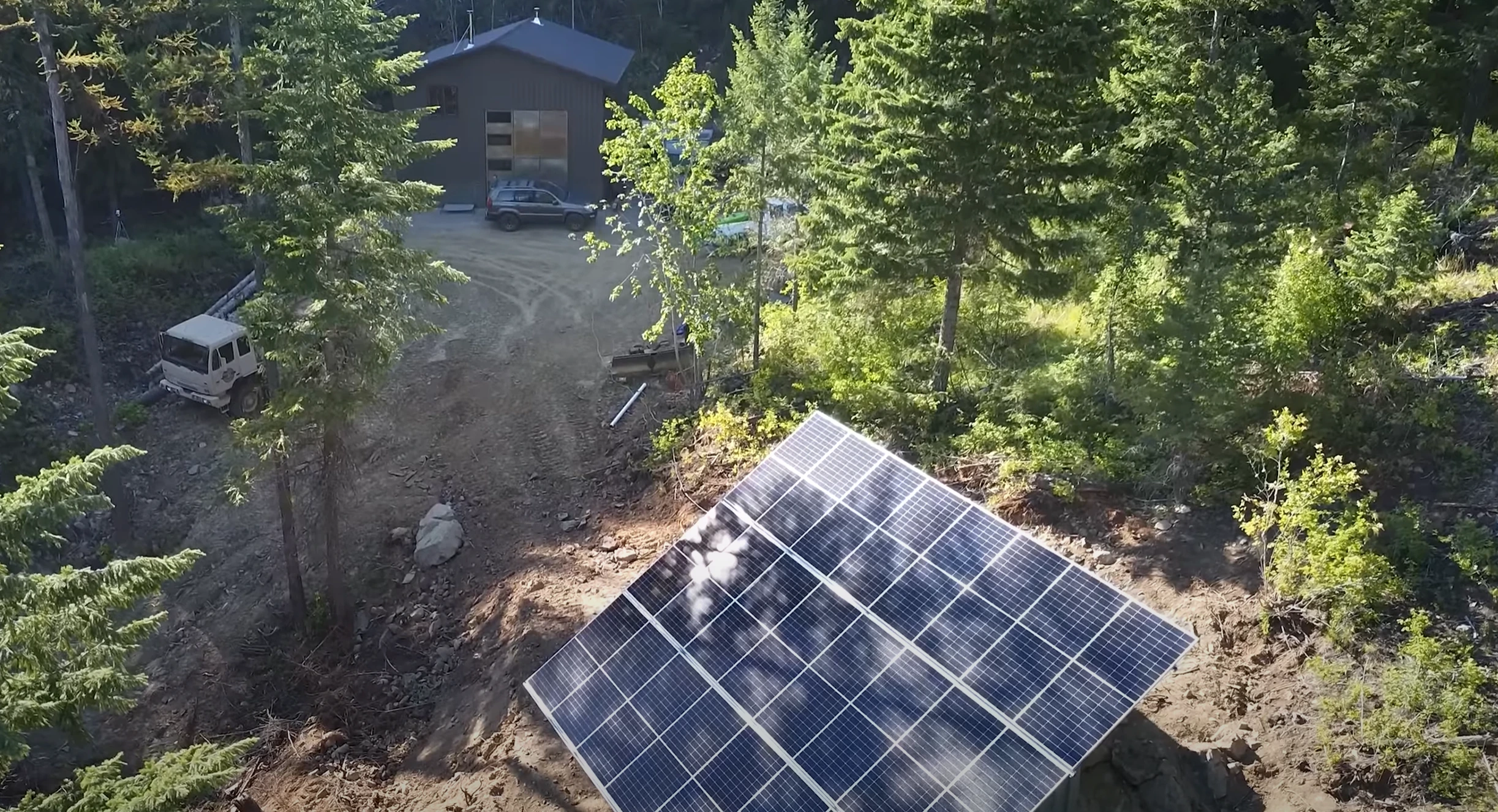 High quality photo of Birdseye view on off-grid property including house, land, panels featured in the Current Connected weekly newsletter. Photographed by Current Connected.
